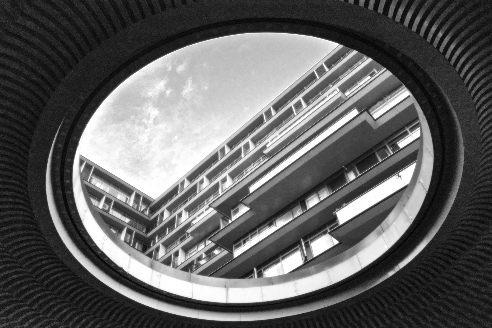 A large building bathed in light seen through a big hole in the ceiling