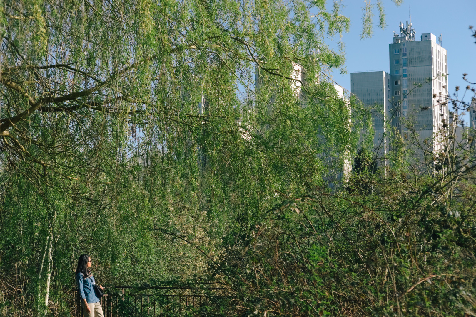 A person juxtaposed against a row of tall buildings in Bures-sur-Yvette